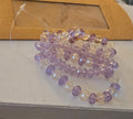 Pulsera cuentas moradas y blancas